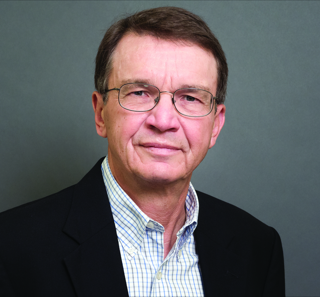 A man wearing glasses and a blue shirt.